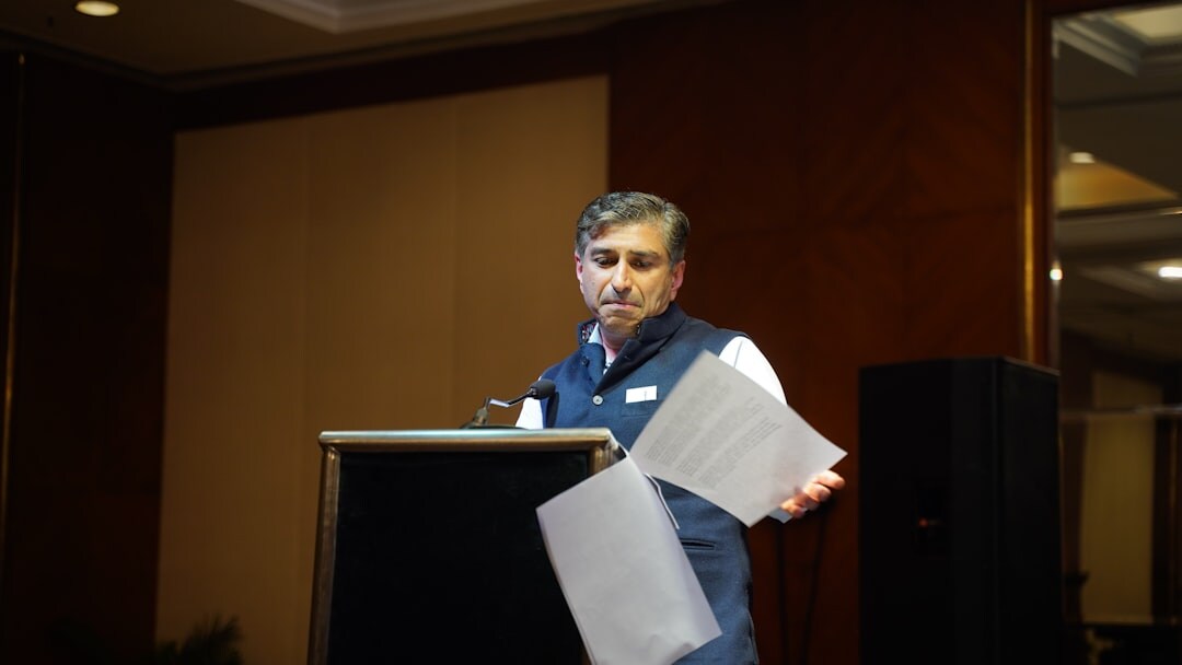 Speaker presenting to an audience at a business conference